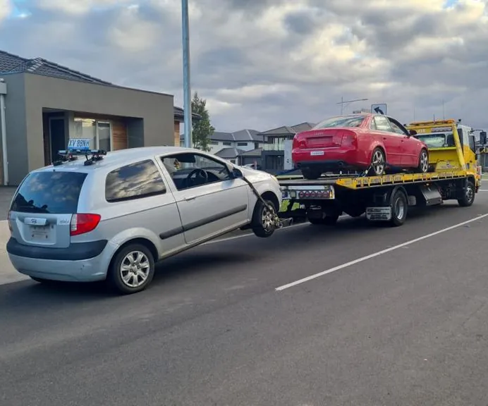 Car removal Melbourne – Gold Car Removals tow truck removing two unwanted cars at once